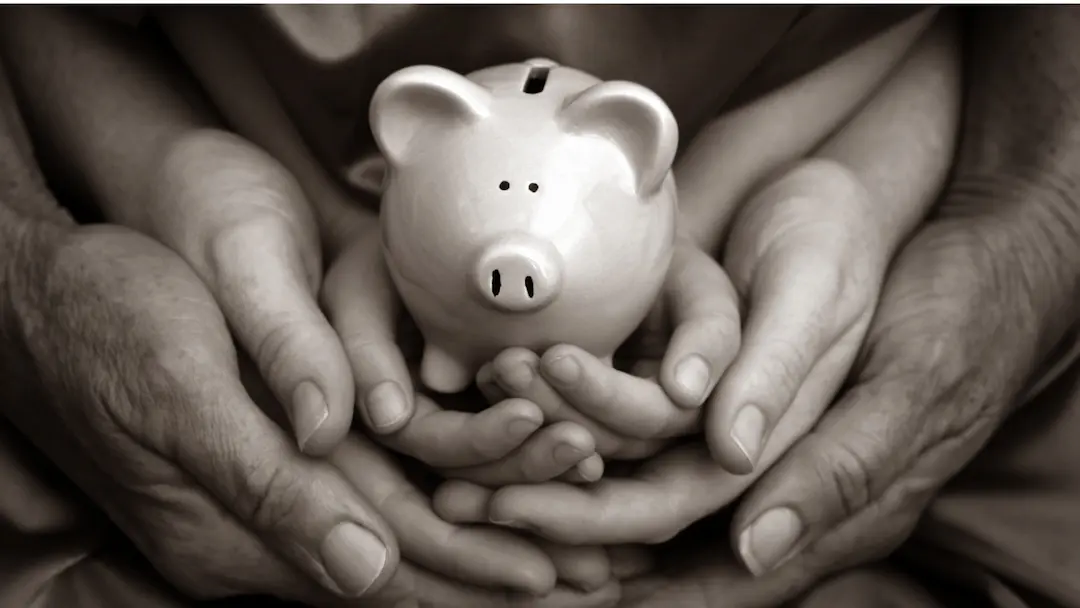 Inheritance Tax Reform 2025 A Strategic Opportunity for Expats For 2025 - Many hands coming together to hold a piggy bank